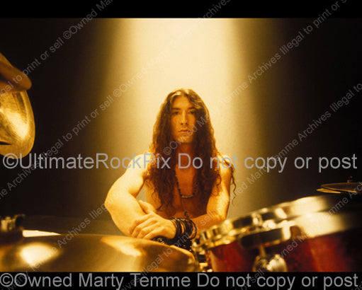 Photo of Sean Kinney of Alice In Chains sitting at his drums during a photo shoot in 1991 by Marty Temme