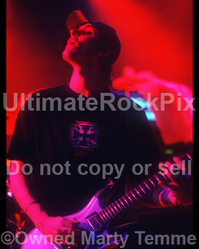 Photo of Benjamin Burnley of Breaking Benjamin playing guitar in concert by Marty Temme
