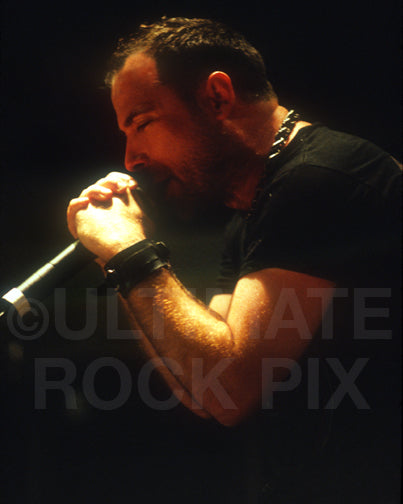 Photo of John Bush of Anthrax singing in concert in 2001 by Marty Temme