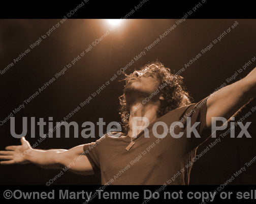 Photo of Chris Cornell with arms held out in concert in 2008 by Marty Temme