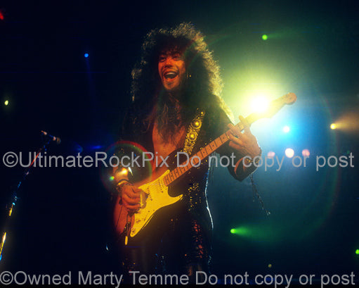 Photo of Jeff LaBar of Cinderella playing a Stratocaster in concert in 1989 by Marty Temme
