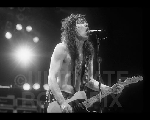 Black and white photo of Tom Keifer of Cinderella playing a Telecaster in concert by Marty Temme