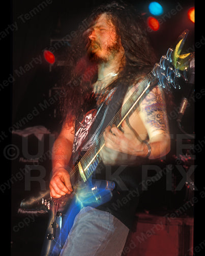Photo of Diamond Darrell Abbott of Pantera playing his Dean guitar in concert in 1994 by Marty Temme