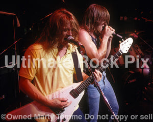 Photo of Eric "A.K." Knutson and Michael Gilbert of Flotsam and Jetsam in concert in 1988 by Marty Temme