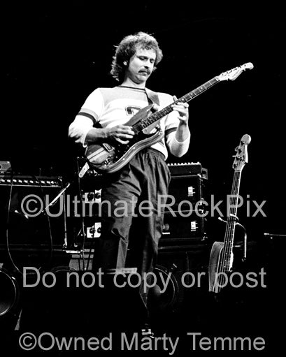 Photo of Daryl Stuermer of Genesis in concert in 1977 by Marty Temme