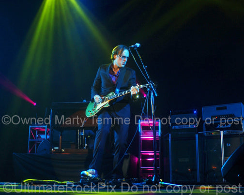 Photo of Joe Bonamassa playing a green Les Paul in concert by Marty Temme