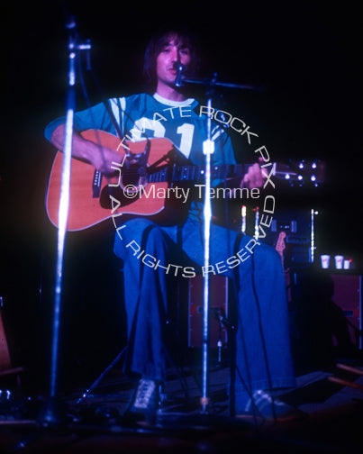 Photo of Jim Messina of Loggins and Messina playing acoustic guitar in 1973 by Marty Temme