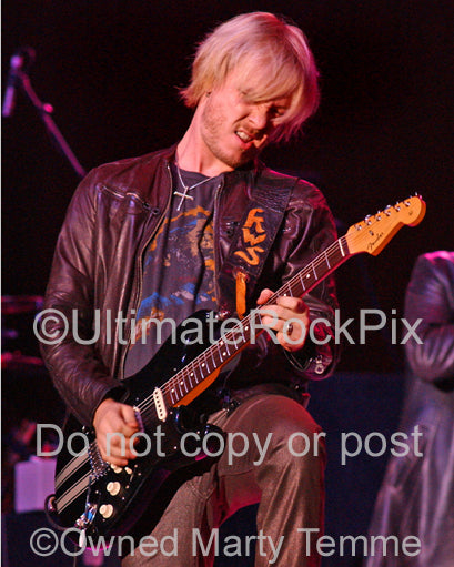 Photo of Kenny Wayne Shepherd playing a black Stratocaster in concert by Marty Temme