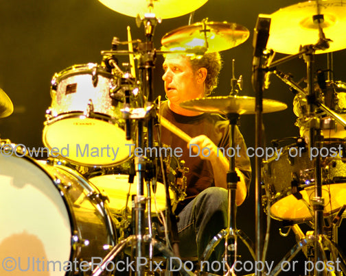 Photo of drummer Mickey Curry of Bryan Adams in concert by Marty Temme