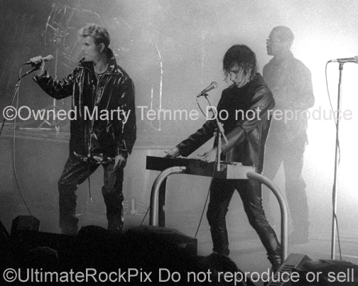 Photo of Trent Reznor of Nine Inch Nails and David Bowie in concert in 1995 by Marty Temme