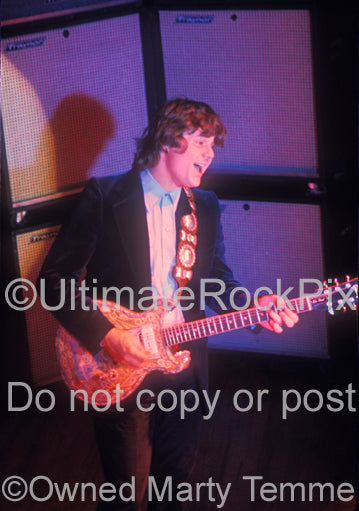 Photo of Steve Miller performing in concert in 1974 by Marty Temme