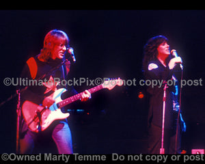 Photo of Paul Kantner and Grace Slick of Jefferson Starship in concert in 1975 by Marty Temme