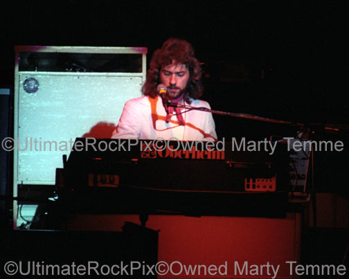Photo of Dennis DeYoung of Styx playing keyboards in concert in 1977 by Marty Temme