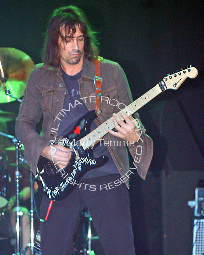 Photo of guitar player Warren DeMartini of Ratt in concert by Marty Temme