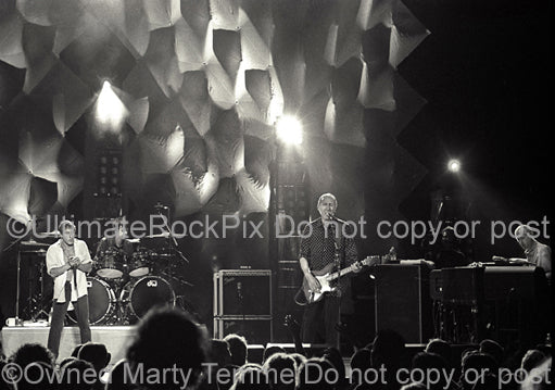 Photo of Pete Townshend, Roger Daltrey, Zak Starkey and John Rabbit Bundrick of The Who in concert in 2000 by Marty Temme