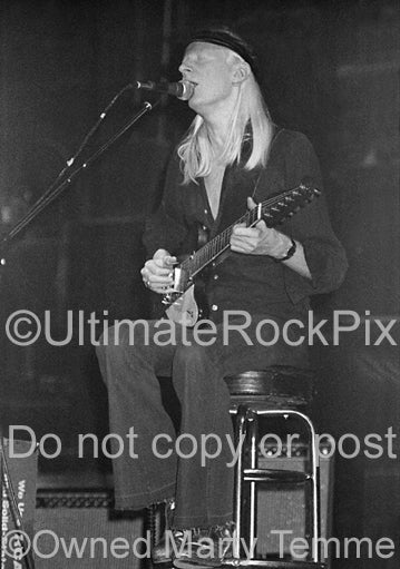 Black and white photo of Johnny Winter playing his Gibson Firebird in concert in 1979 by Marty Temme