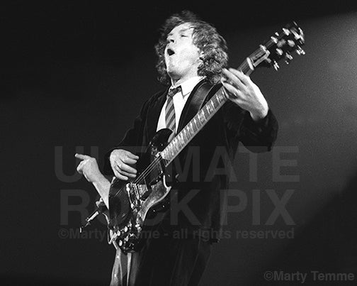 Photo of Angus Young of AC/DC performing onstage by Marty Temme.