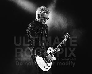 Black and white photo of Billy Duffy playing his Les Paul in concert by Marty Temme