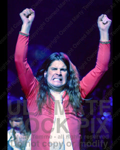 Photo of Ozzy Osbourne of Black Sabbath raising his arms to the crowd in 1978 by Marty Temme