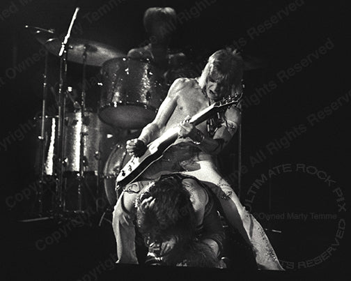 Black and white photo of David Bowie and Mick Ronson in concert in 1973 by Marty Temme