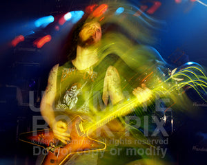 Photo of Darrell Abbott of Pantera playing a Dean guitar in concert in 1994 by Marty Temme