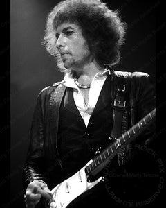 Black and white photo of Bob Dylan playing a Fender Stratocaster in concert in 1978 by Marty Temme