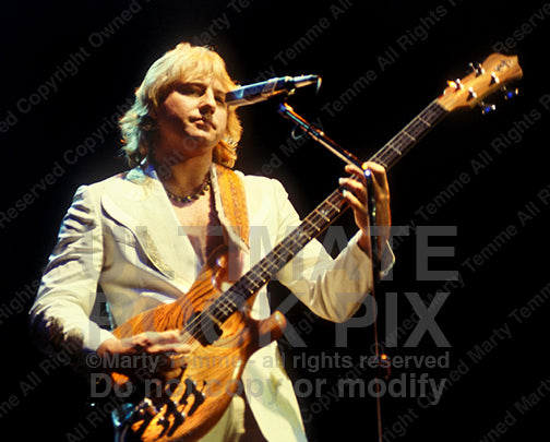 Photo of Greg Lake of Emerson, Lake and Palmer and King Crimson in concert in 1978 by Marty Temme