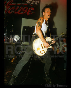 Photo of Tracii Guns of L.A. Guns playing a Les Paul in concert in 1991 in Hollywood, California by Marty Temme