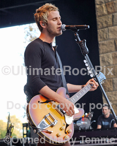 Photo of Jason Wade of Lifehouse playing guitar in concert by Marty Temme