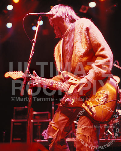 Photo of Kurt Cobain of Nirvana playing his Fender Jaguar in concert in 1991 by Marty Temme