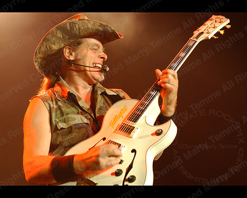 Photo of Ted Nugent playing a white Gibson Byrdland in 2005 by Marty Temme