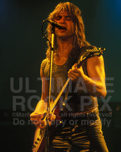 Photo of Charlie Huhn of Ted Nugent in concert in 1980 by Marty Temme