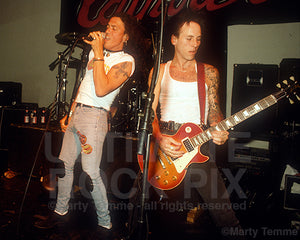 Photo of Stephen Pearcy of Ratt and Tracii Guns of L.A. Guns
onstage in 1991 by photographer Marty Temme