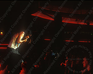 Photo of Eddie Vedder of Pearl Jam performing in concert in 1991 in Hollywood, California by Marty Temme