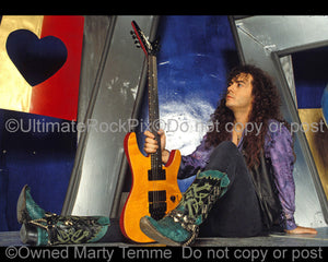 Photo of Tim Kelly of Slaughter with his guitar during a photo shoot in 1991 by Marty Temme