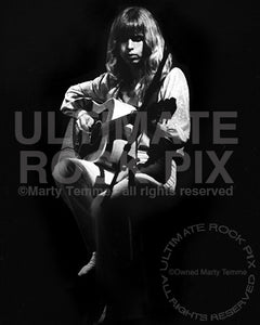 Black and white photo of Tommy Shaw of Styx playing acoustic guitar in concert in 1978 by Marty Temme