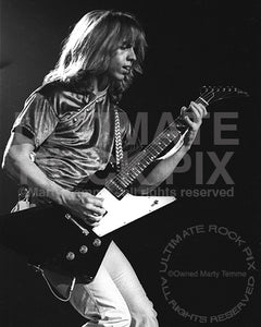 Photo of Tommy Shaw of Styx playing a Gibson Explorer in concert in 1979 by Marty Temme