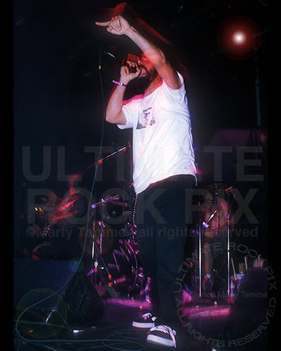 Photo of singer Serj Tankian of System of a Down in concert in 1998 by Marty Temme