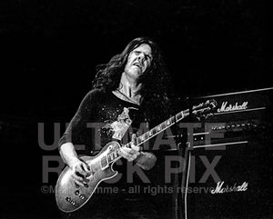 Photo of guitarist Gary Moore of Thin Lizzy in concert in 1977 by Marty Temme