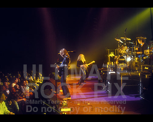 Photo of Scott Gorham, John Sykes and Michael Lee of Thin Lizzy in concert by Marty Temme