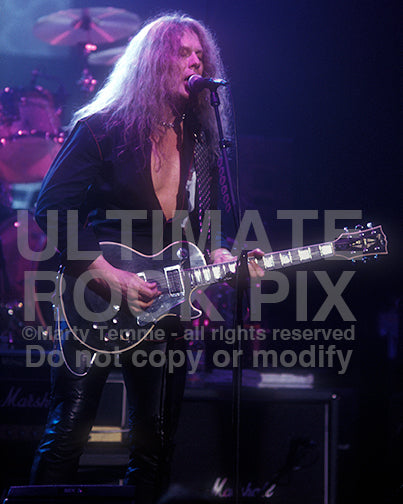 Photo of guitarist John Sykes of Thin Lizzy in concert by Marty Temme