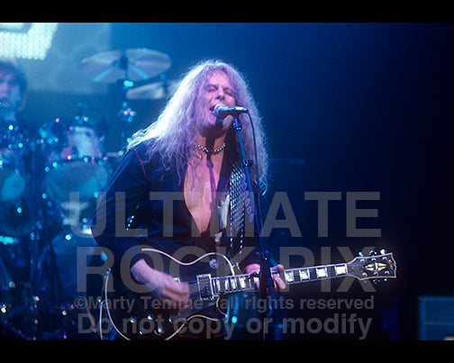 Photo of guitar player John Sykes of Thin Lizzy in concert by Marty Temme