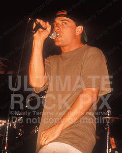 Photo of Whitfield Crane of Ugly Kid Joe in concert in 1992 by Marty Temme