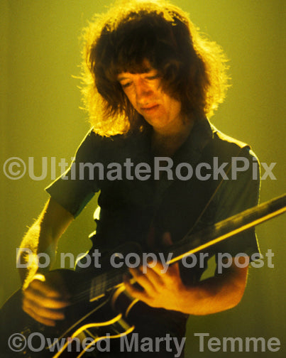 Photo of guitarist Brad Whitford of Aerosmith playing a Gibson Les Paul in concert in 1980 by Marty Temme