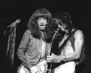 Photos of guitar players Joe Perry and Brad Whitford of Aerosmith in concert in 1974 by Marty Temme
