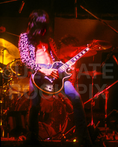 Photo of Joe Perry of Aerosmith in concert in 1975 by Marty Temme