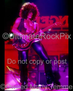 Photo of guitarist Joe Perry playing slide on a Dan Armstrong Plexi guitar by Marty Temme