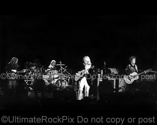 Photo of Gerry Beckley, Dewey Bunnell, Willie Leacox and Dan Peek of the band America in concert in 1977 by Marty Temme