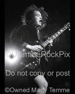 Photos of Angus Young of AC/DC Playing a Gibson SG in Concert by Marty Temme