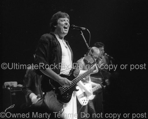 Photo of Chas Chandler of The Animals in concert in 1983 by Marty Temme
